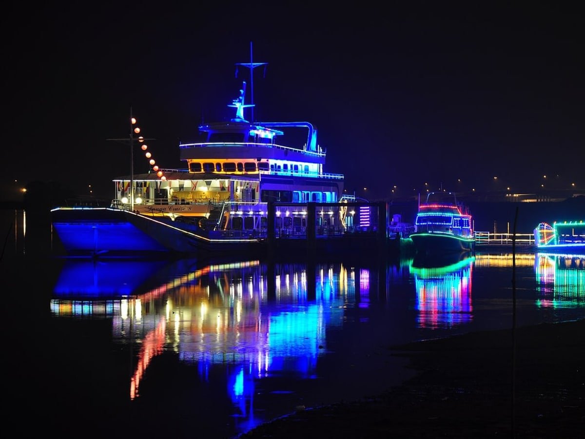 Colourful boats reflected in the water at Danga Bay at night